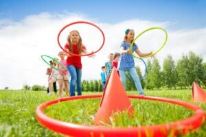 Kids,Throw,Colorful,Hoops,On,Cones,While,Competing